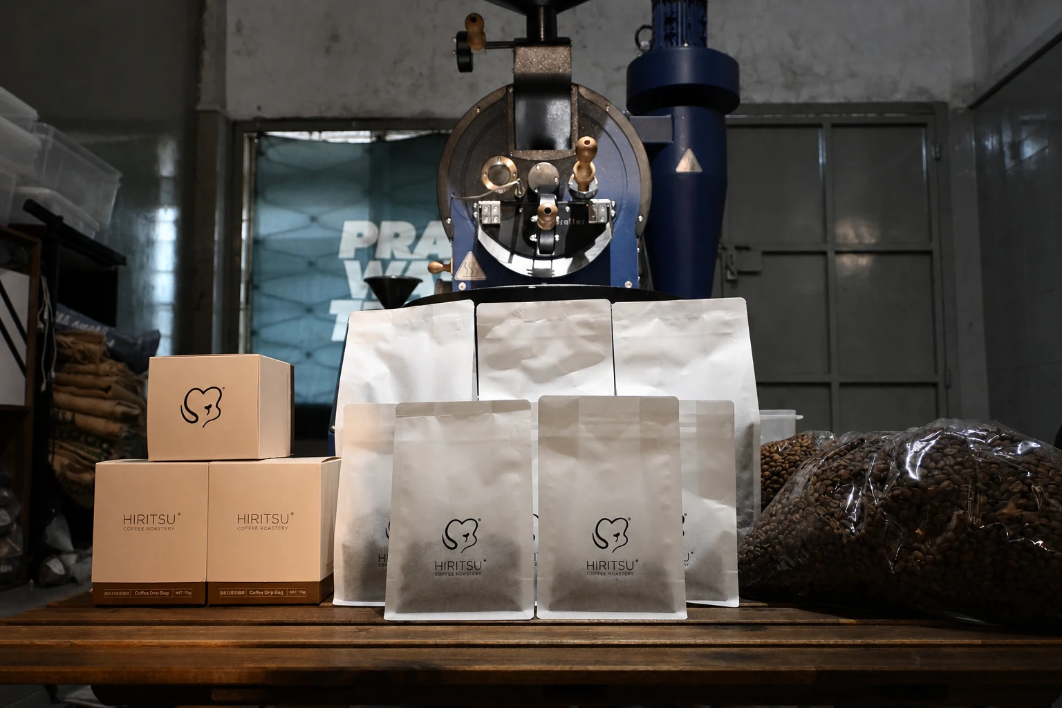 Hiritsu coffee bags and beans arranged in front of the roaster